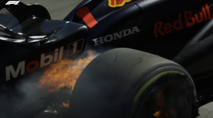 Max Verstappen's right rear wheel is engulfed in flames.